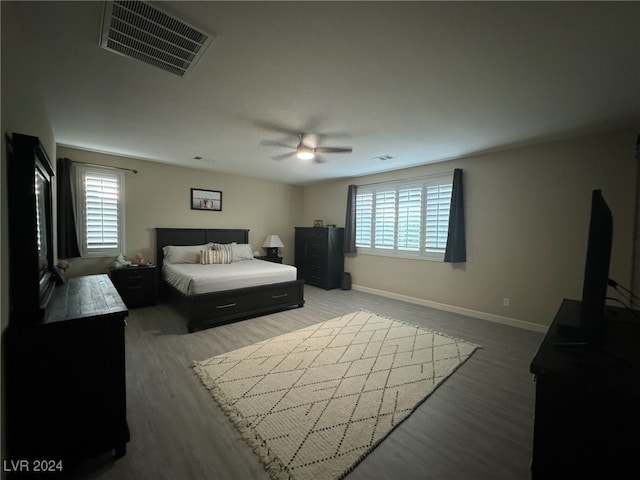 bedroom with ceiling fan and hardwood / wood-style floors