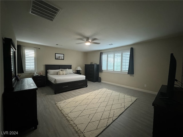 bedroom with hardwood / wood-style floors and ceiling fan