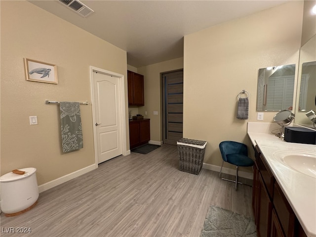 bathroom with vanity and hardwood / wood-style flooring