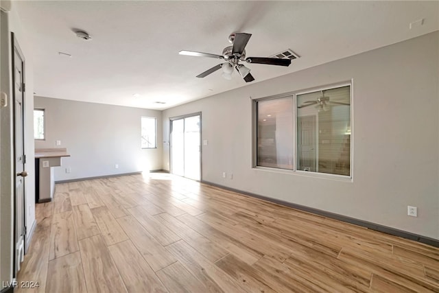 unfurnished living room featuring ceiling fan and light hardwood / wood-style flooring