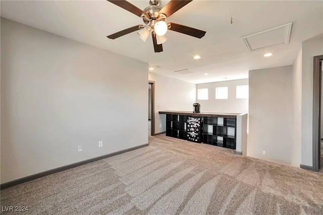 unfurnished living room with ceiling fan and carpet flooring