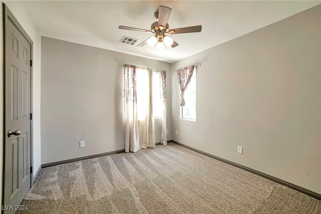 interior space with ceiling fan and light carpet