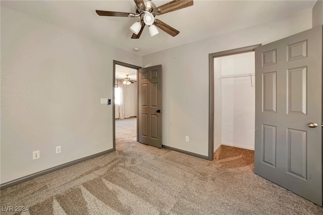 unfurnished bedroom with a closet, ceiling fan, and light colored carpet