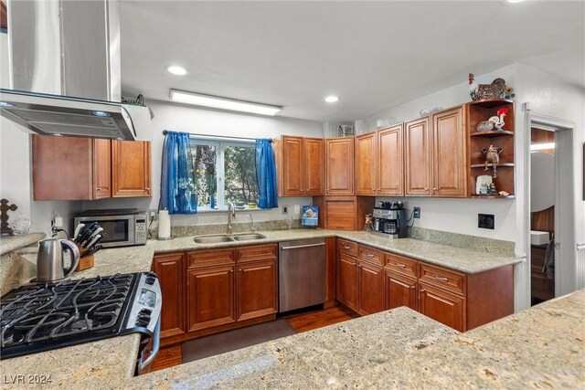 kitchen featuring ventilation hood, sink, light stone counters, and appliances with stainless steel finishes