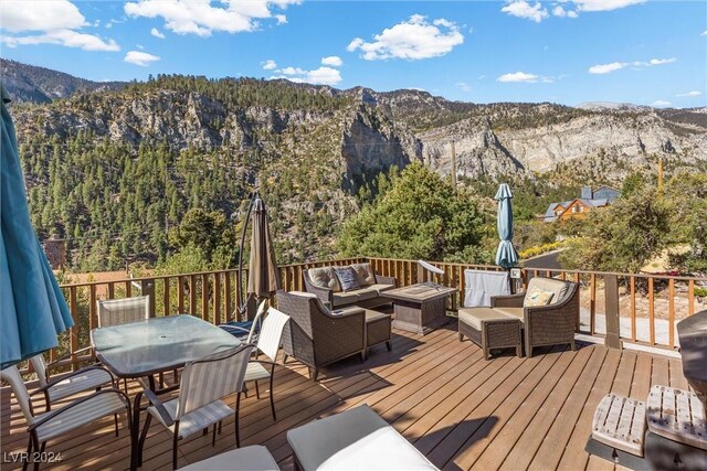 deck with a mountain view and an outdoor hangout area