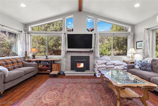 sunroom / solarium with lofted ceiling with beams and a wood stove