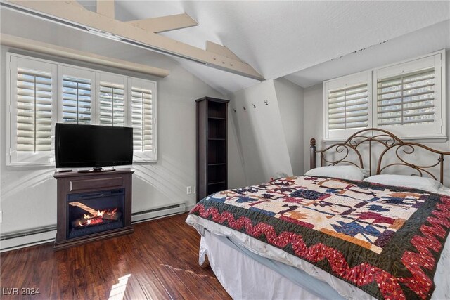 bedroom with dark wood-type flooring, baseboard heating, and lofted ceiling