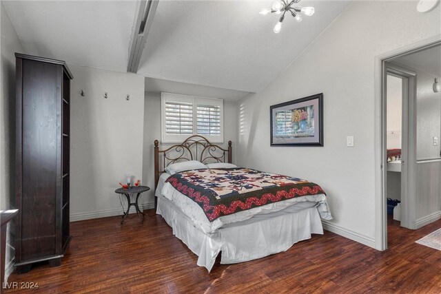 bedroom featuring dark hardwood / wood-style flooring, an inviting chandelier, and lofted ceiling