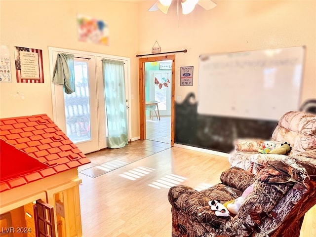 living room featuring ceiling fan and hardwood / wood-style floors