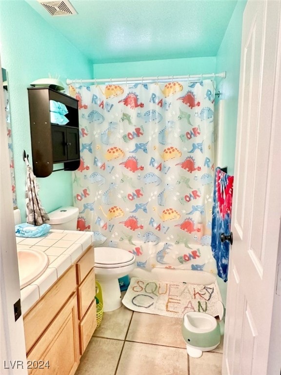 full bathroom with tile patterned flooring, vanity, toilet, and shower / bath combination with curtain