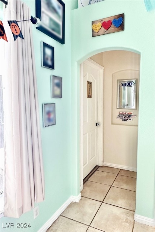 hall featuring light tile patterned flooring