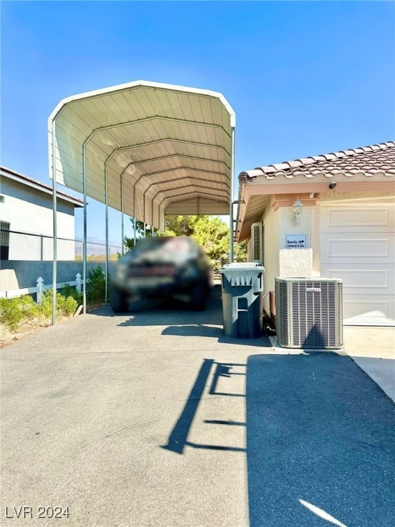 view of vehicle parking featuring a carport and a garage