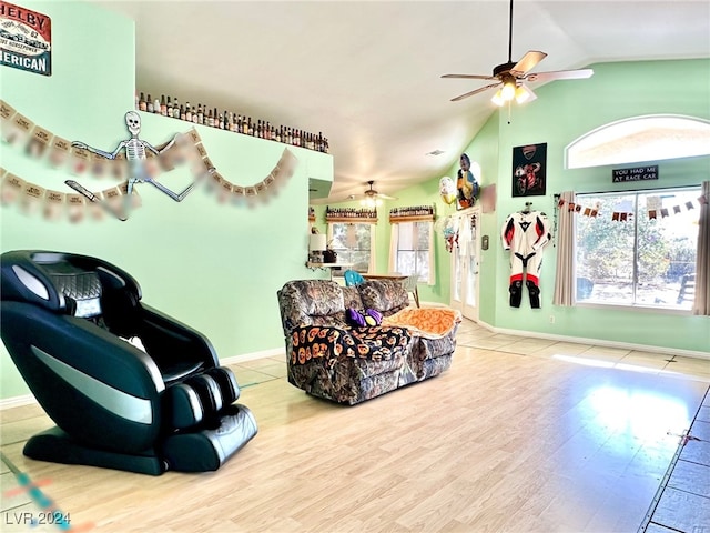 interior space with ceiling fan, lofted ceiling, plenty of natural light, and hardwood / wood-style floors