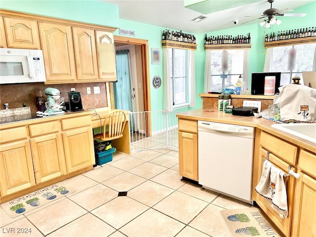 kitchen featuring tasteful backsplash, white appliances, light tile patterned floors, light brown cabinetry, and ceiling fan