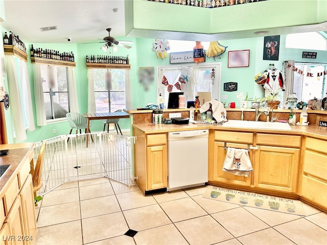 kitchen with dishwasher, ceiling fan, light tile patterned flooring, and sink