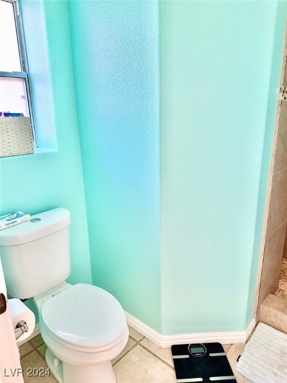 bathroom featuring tile patterned flooring and toilet