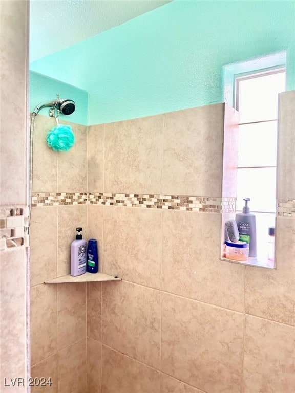 bathroom with a tile shower