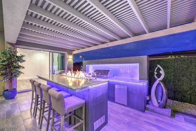 interior space featuring light wood-type flooring and stone countertops