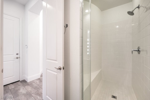 bathroom featuring a shower with door