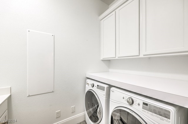 laundry room with cabinets and washer and dryer