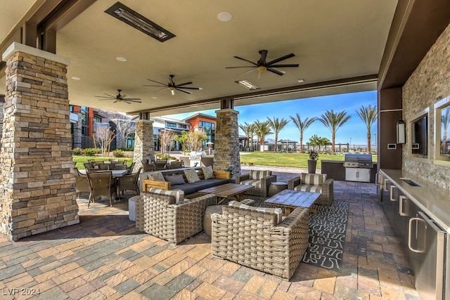 view of patio / terrace with ceiling fan, outdoor lounge area, a grill, and exterior kitchen