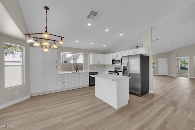 kitchen with a healthy amount of sunlight, appliances with stainless steel finishes, and vaulted ceiling