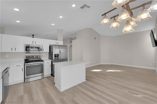 kitchen featuring a center island, stainless steel appliances, lofted ceiling, white cabinets, and light hardwood / wood-style flooring