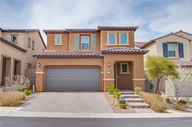 mediterranean / spanish-style home featuring a garage