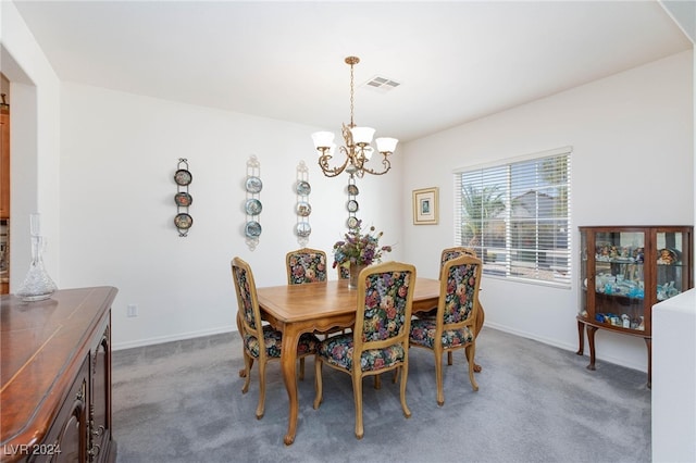 carpeted dining room featuring a chandelier