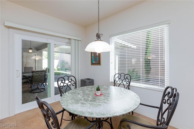 tiled dining space featuring plenty of natural light