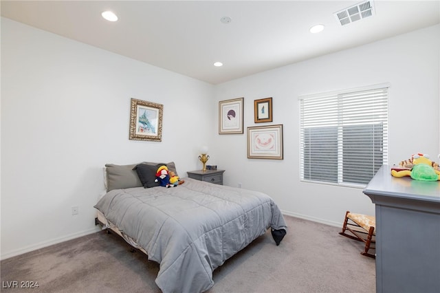 bedroom with light colored carpet