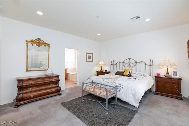 bedroom featuring carpet floors and ensuite bath