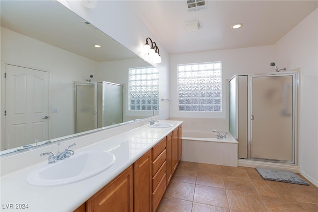 bathroom with tile patterned flooring, separate shower and tub, and vanity