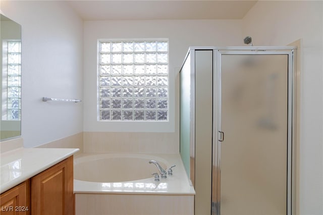 bathroom featuring vanity and separate shower and tub