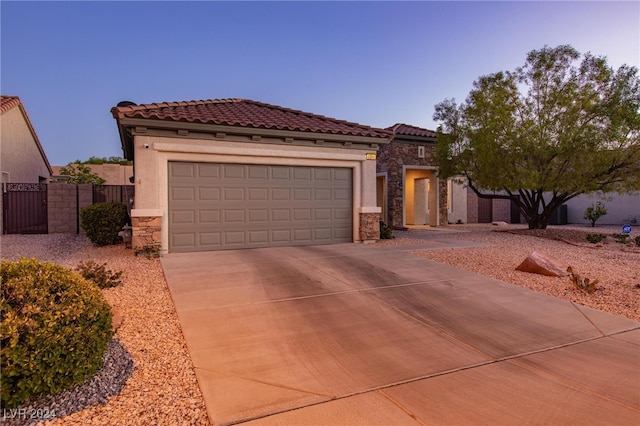 mediterranean / spanish-style home featuring a garage