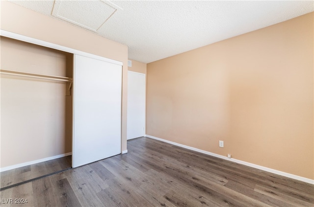 unfurnished bedroom with hardwood / wood-style floors and a closet