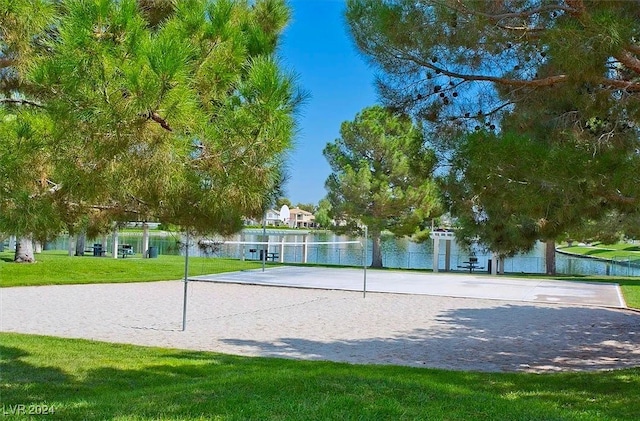 surrounding community featuring a water view, volleyball court, and a yard