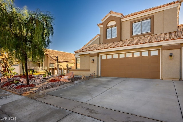 mediterranean / spanish-style home featuring a garage