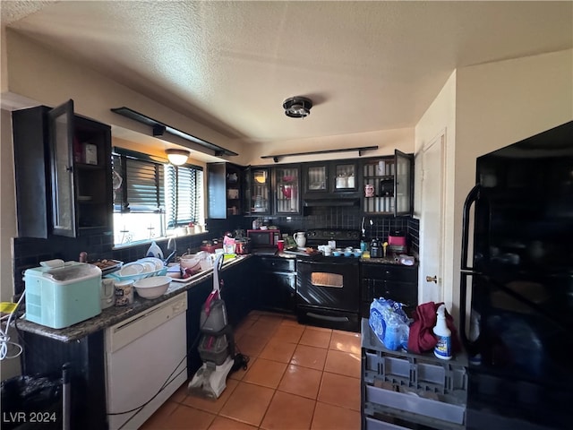 kitchen featuring a textured ceiling, light tile patterned flooring, electric range, and white dishwasher