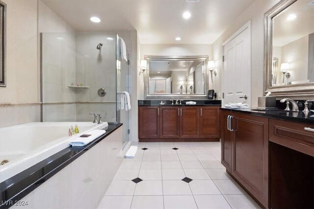 bathroom featuring shower with separate bathtub, vanity, and tile patterned floors