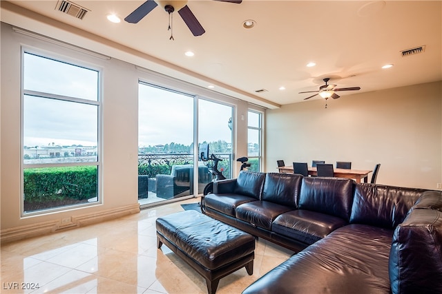 living room featuring a healthy amount of sunlight and ceiling fan