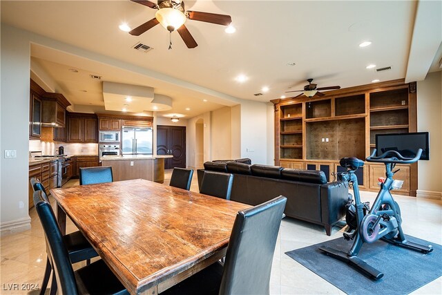 tiled dining space featuring ceiling fan