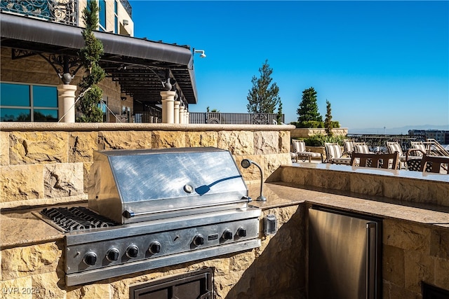 view of patio / terrace featuring area for grilling and a grill