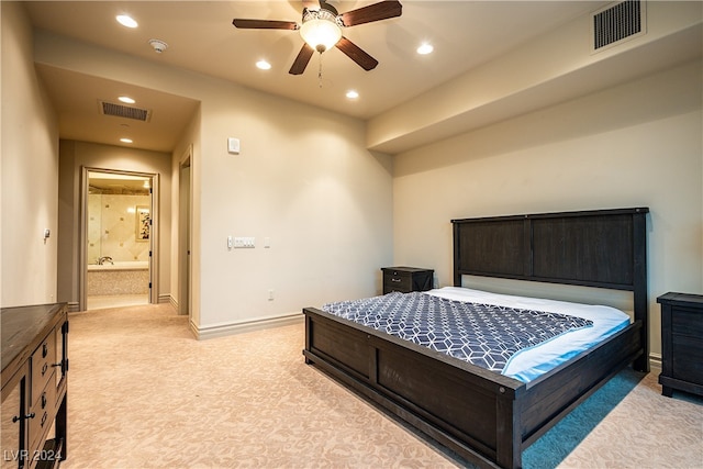 carpeted bedroom featuring ensuite bath and ceiling fan