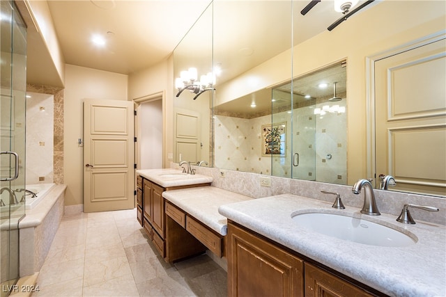 bathroom featuring vanity, an inviting chandelier, and plus walk in shower