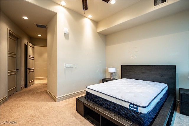 bedroom featuring light carpet and ceiling fan