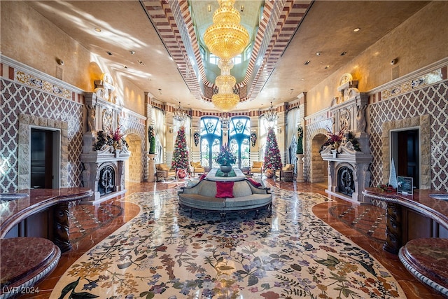 interior space with a notable chandelier, a high ceiling, a fireplace, and french doors