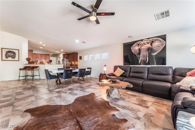 living room with ceiling fan and lofted ceiling