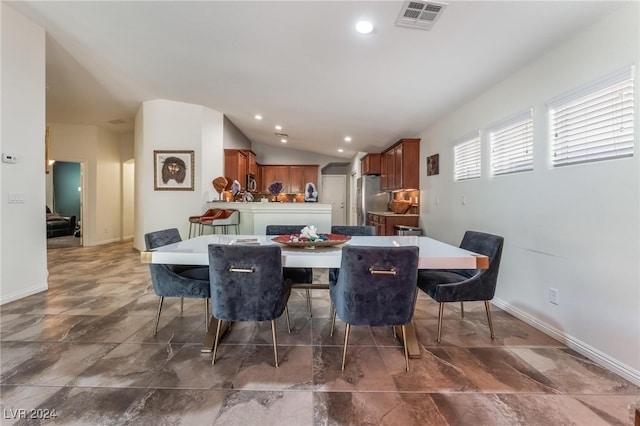 dining area featuring lofted ceiling