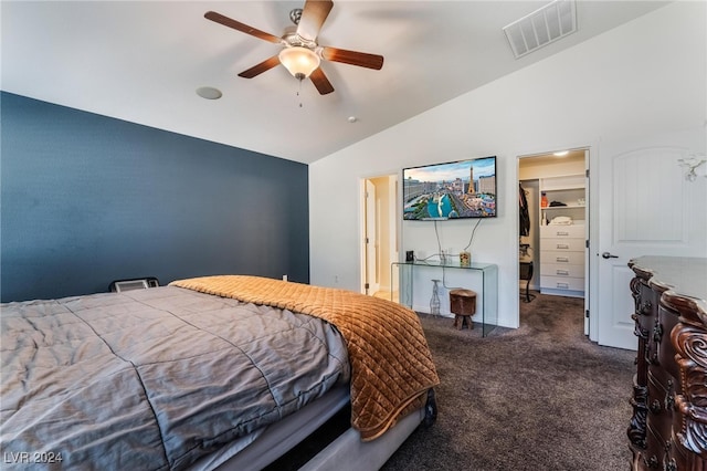 carpeted bedroom featuring a spacious closet, a closet, lofted ceiling, and ceiling fan